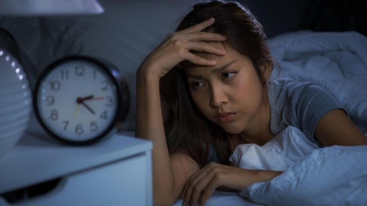 Person checking clock during restless night