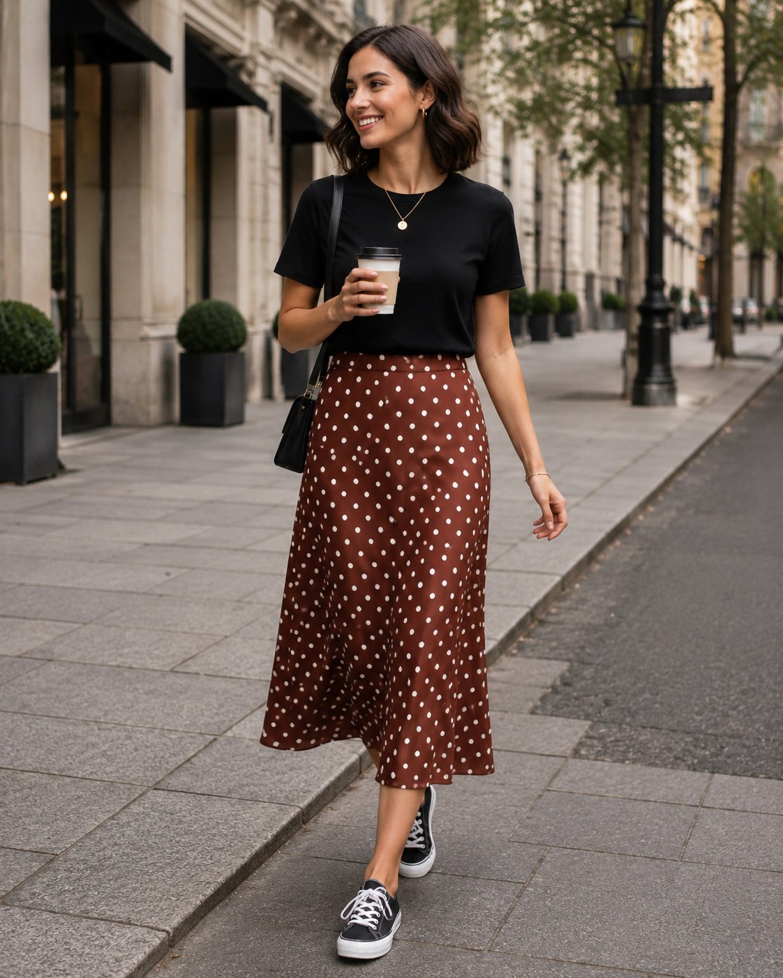 A polka-dot button-front midi skirt styled with a black tee and sneakers for errands.